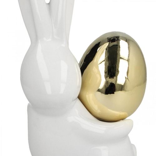 Artículo Conejitos de Pascua elegantes, conejitos de cerámica con huevo dorado, decoración de Pascua blanco, dorado Al. 18 cm 2 piezas