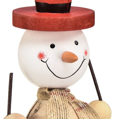 Artículo Figura decorativa muñeco de nieve de madera con sombrero rojo natural Al. 20,5 cm